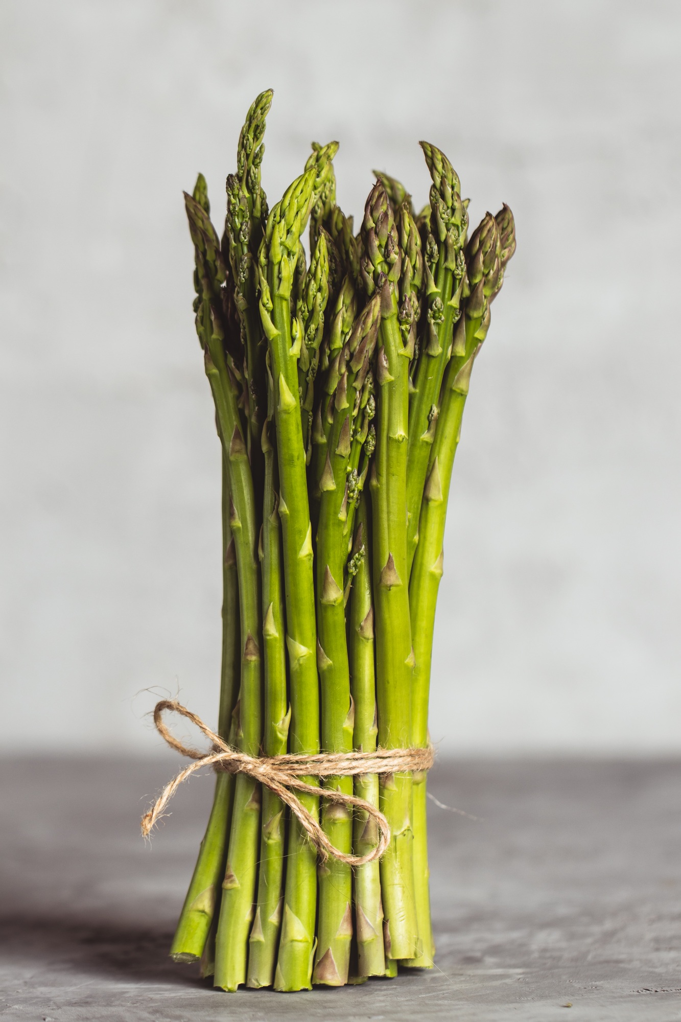 Fresh green spring asparagus on a wooden background. Asparagus season